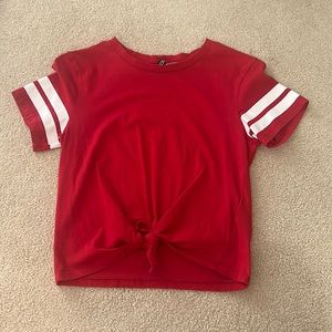 Lightly used H&M Divided US S Red Tee w/ White Stripes ties at the bottom
